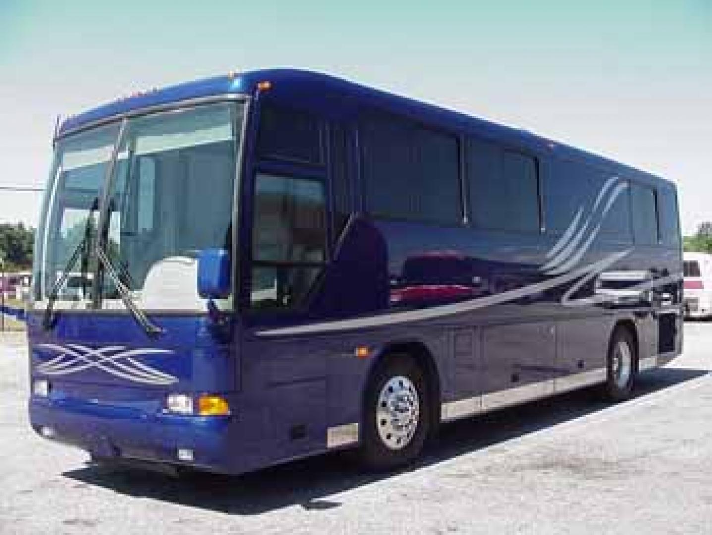2002 Blue /Red/Gray MCI F3500 with an 300 Cummins engine, Allison transmission, 0.000000, 0.000000 - 2002 MCI F3500 300 Cummins Diesel Engine – Allison Automatic Transmission - 35' Long - Raised Roof - Front Lounge – Kitchen - Restroom with Shower - Rear Bedroom - Slide outs in luggage bays - 12.5 KW Kubota Generator - 3 Roof Heat Pumps - Aluminum wheels - 11,000 Total Coach Miles - Photo#1