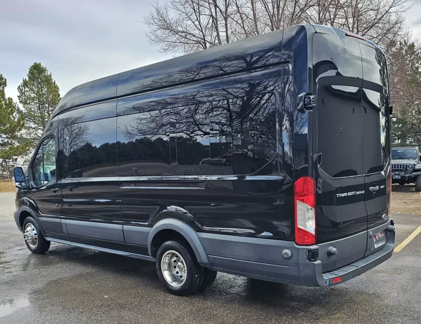 2017 Black /Black Ford Transit with an Gas engine, Auto transmission, 0.000000, 0.000000 - 2017 FORD TRANSIT 3.7L GAS ENGINE BUILT BY PINNICALE INTERIOR BLACK DIAMOND PATTERN LIMO BENCH SEATS 10 PASSENGERS PLUS DRIVER AND COPILOT - RACK LIMO BENCH SEATING POWER PARTITION TV'S FRONT AND REAR COVED RGB LIGHTING ON SIDE WALLS OVER HEAD DOME LIGHTS GRAY WOOD LOOK FLOORING MAYBACH CEILING LIGH - Photo#2
