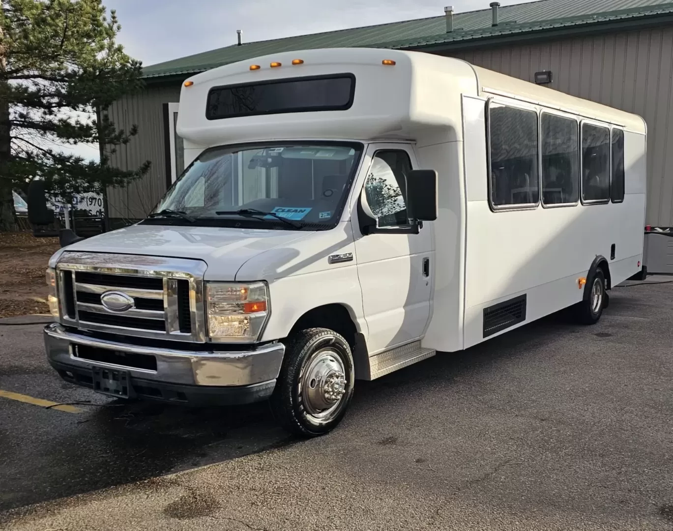 2015 White /Black Ford E450 with an V10 engine, Auto transmission, 0.000000, 0.000000 - 2015 FORD E450 CHAMPION - CHALLENGER V-10 GAS 24 PASSENGER PLUS DRIVER WHITE EXTERIOR EXECUTIVE SHUTTLE BLACK EXECUTIVE SEATS AISLE ARMREST LAP BELTS RECLINER SEATS WOOD LOOK FLOORING REAR LUGGAGE AND MUCH MORE! - WELL MAINTAINED FINANCING AVAILABLE LOCATED IN FT COLLINS - Photo#0
