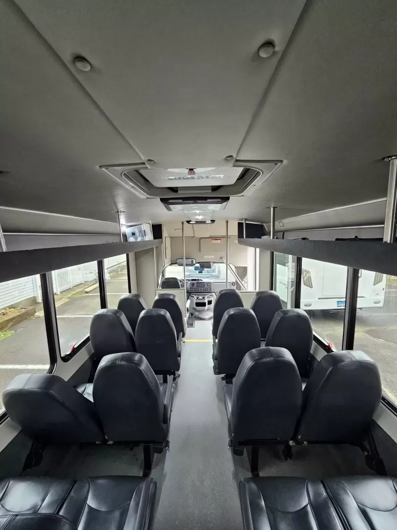 2019 White /Black Ford E450 with an V10 engine, Auto transmission, 0.000000, 0.000000 - 2019 FORD E450 STARCRAFT WHITE EXTERIOR 6.8L V10 GAS ENGINE 25 PASSENGERS GRAY RUBBER FLOORING TRANS AIR REAR A/C SYSTEM FLOOR HEATER NEW BLACK HIGH BACK SEATS, W/ RECLINE, RETRACTABLE LAP BELTS, SEAT SIDE SLIDERS AND ARMRESTS REAR LUGGAGE (DOOR) NO LUGGAGE SPACE CENTER MOUNT FLIP DOWN TV'S (2) BACK - Photo#19